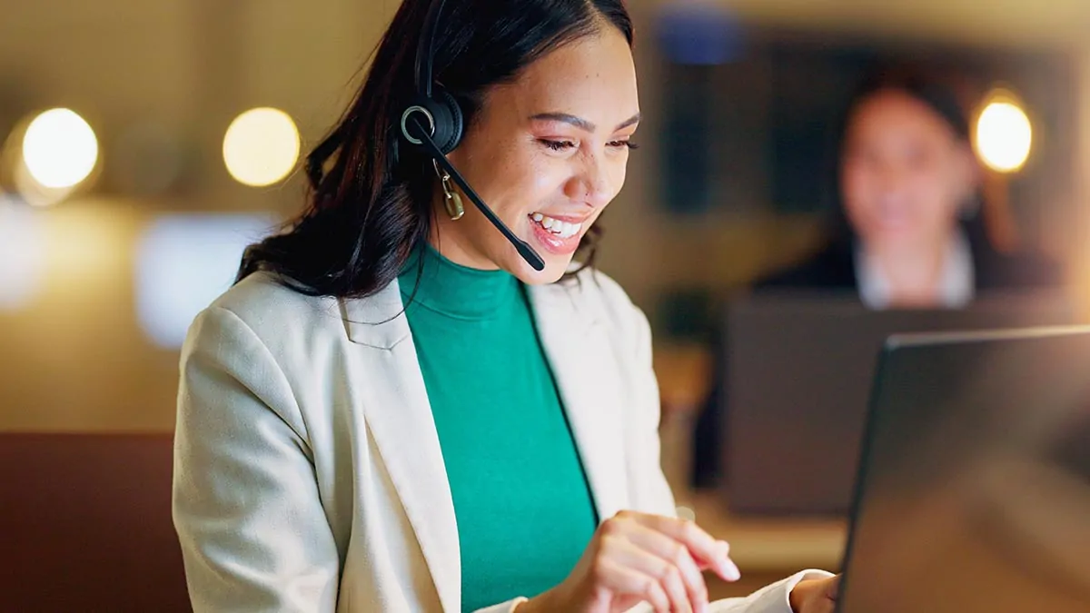 Friendly customer support representative assisting with eWEAT products via headset and laptop - eweat.com